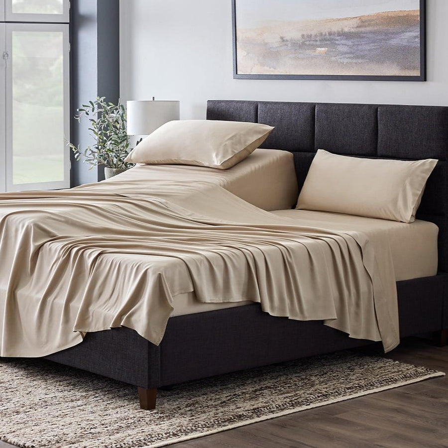 Driftwood Smooth Bamboo Rayon sheets spread across a made bed, three-quarter view